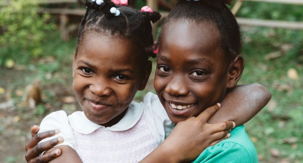 Two children outside a clinic