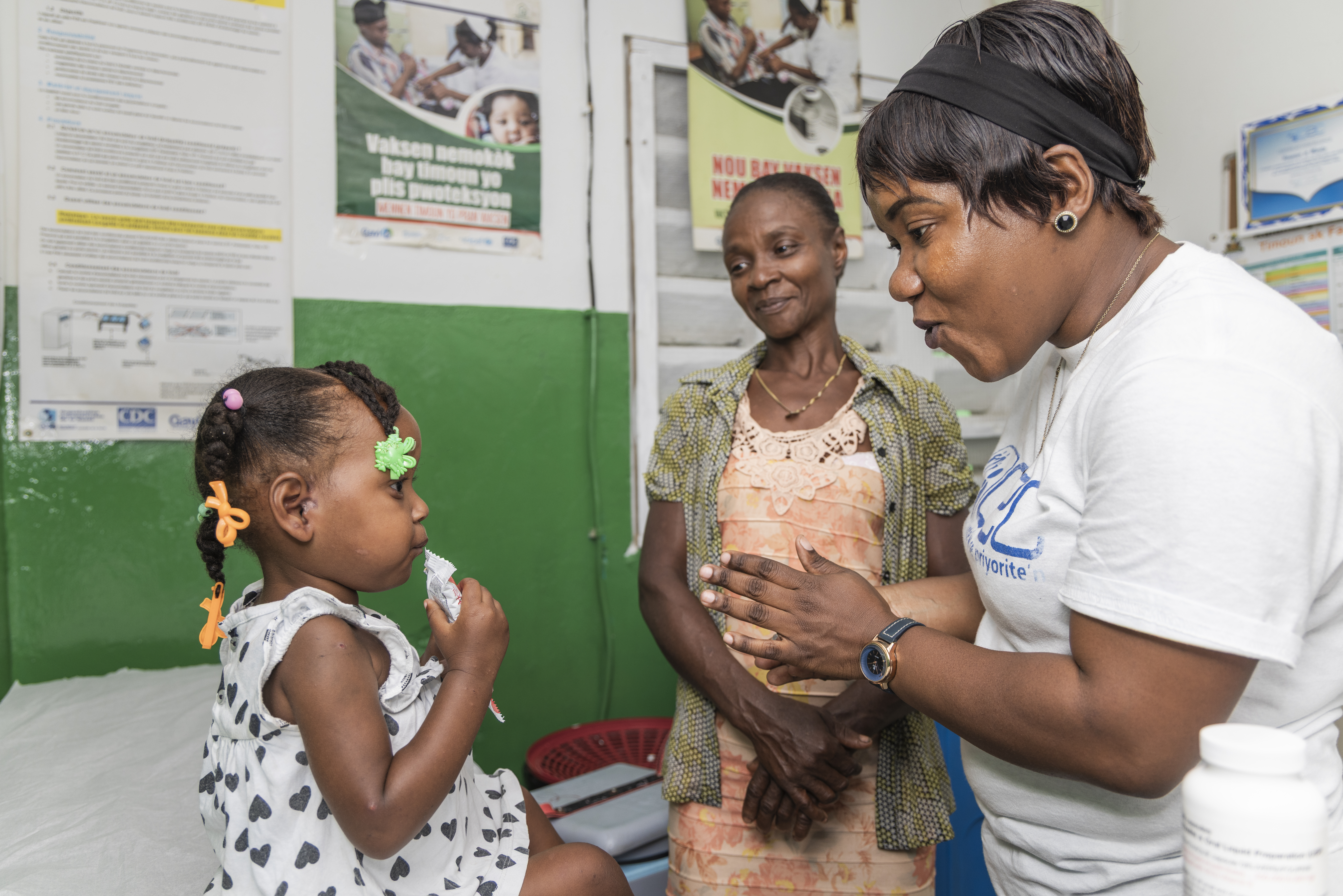Cover photo of nurse with mother and child